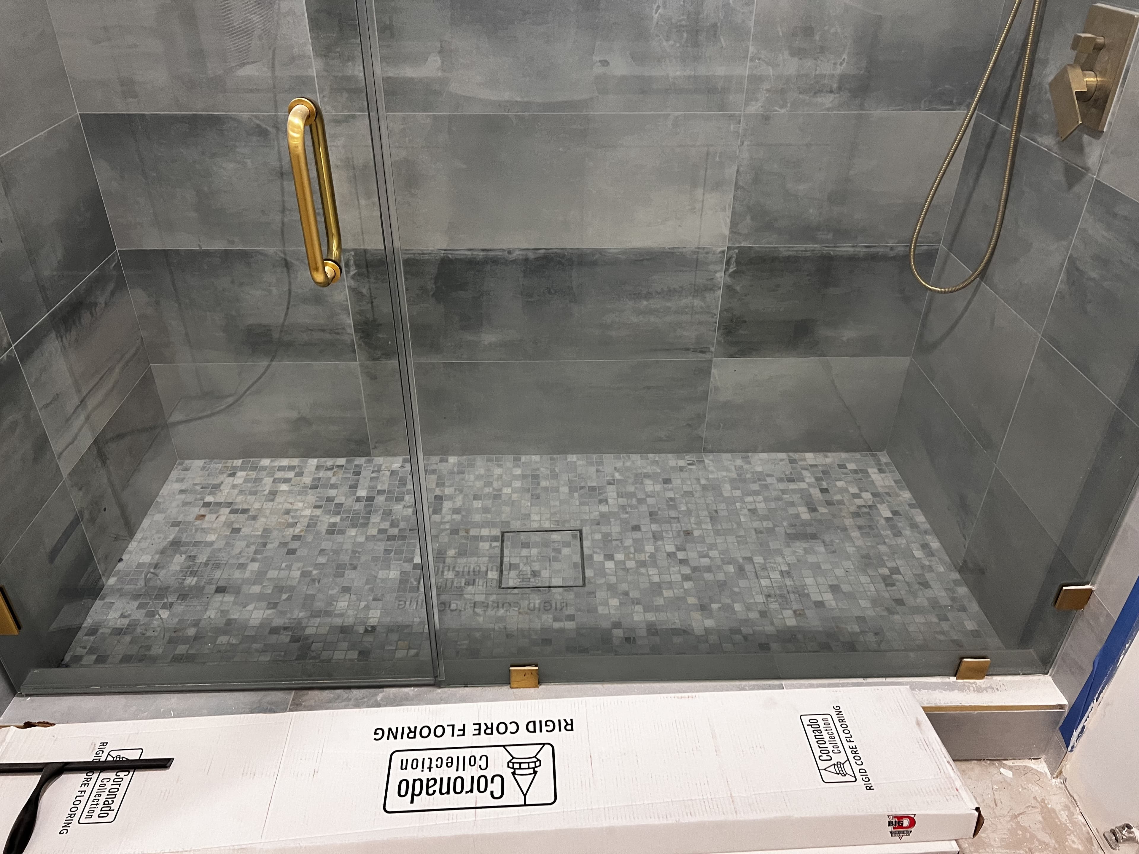 Walk-in shower with grey stone tile walls
